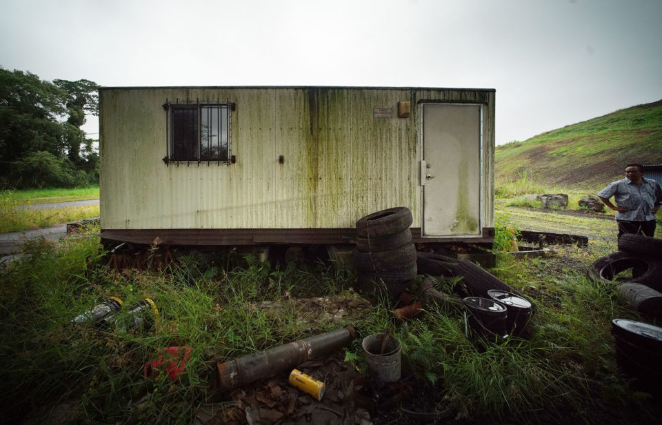 Michael Makekau stands in front of the scale house where he was sickened by mold from an air conditioner at the Hilo landfill.